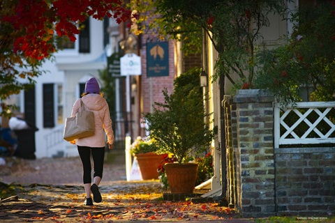 woman walking down downtown Dover street